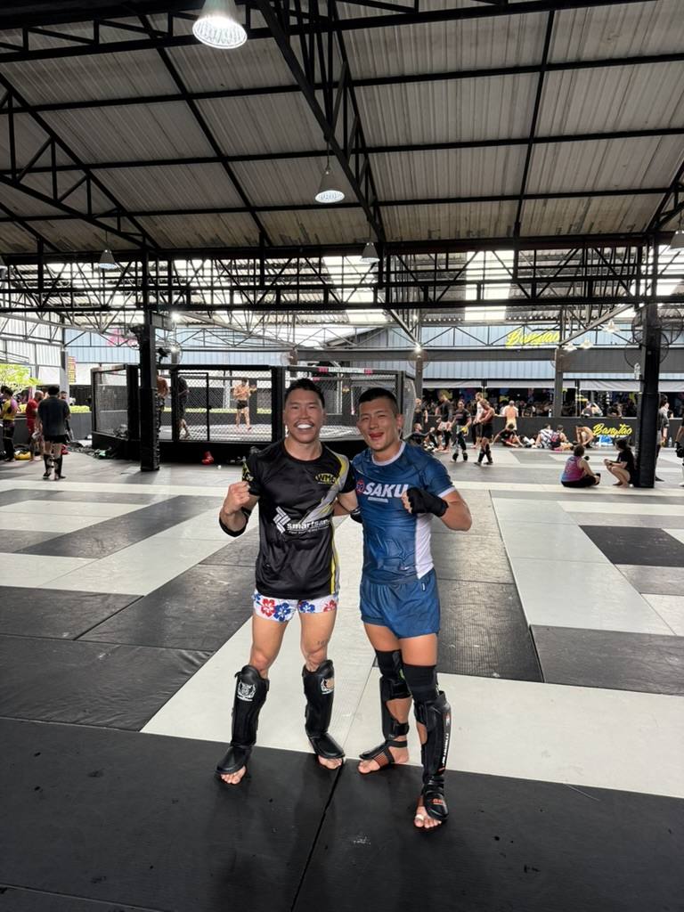 Damien Tse with a fellow combat athlete